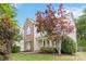 Charming two-story home with front porch and well-manicured yard with various trees at 1308 Pennington Nw Pl, Concord, NC 28027