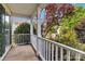 Inviting front porch with white columns and railing overlooking beautifully landscaped front yard at 1308 Pennington Nw Pl, Concord, NC 28027