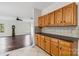 View from kitchen into living room with hardwood flooring and oak cabinets at 1308 Pennington Nw Pl, Concord, NC 28027