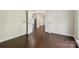Bright room with wood floors leads through double doors to another room at 1308 Pennington Nw Pl, Concord, NC 28027