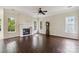 Spacious living room featuring a fireplace, many windows and hardwood flooring at 1308 Pennington Nw Pl, Concord, NC 28027