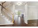 Open-concept living room with wood-look tile floors, fireplace and lots of light at 1308 Pennington Nw Pl, Concord, NC 28027