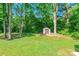 Well-manicured backyard with lush green lawn and a storage shed at 137 Ole Eastpointe Dr, York, SC 29745