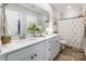 Bright bathroom featuring a white double vanity, a large mirror, and a shower curtain at 137 Ole Eastpointe Dr, York, SC 29745