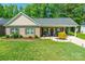 Inviting brick home featuring a cozy front porch, landscaped yard, and charming curb appeal at 137 Ole Eastpointe Dr, York, SC 29745