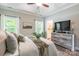 Comfortable bedroom with a ceiling fan, wooden dresser, and a king-size bed topped with neutral throw pillows at 137 Ole Eastpointe Dr, York, SC 29745