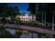 Expansive backyard of a luxurious home with a patio overlooking the waterfront at 140 Lightship Dr, Mooresville, NC 28117