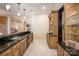 Open wet bar with a sink, cabinetry, and sleek black granite countertops at 140 Lightship Dr, Mooresville, NC 28117