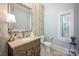 Elegant powder room with patterned wallpaper, decorative mirror and stained glass window at 140 Lightship Dr, Mooresville, NC 28117