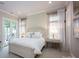 Bright bedroom featuring neutral tones, plush bedding and doors leading to a patio at 140 Lightship Dr, Mooresville, NC 28117