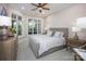 Serene bedroom featuring a gray upholstered bed, neutral tones, and large windows creating a calming and inviting atmosphere at 140 Lightship Dr, Mooresville, NC 28117