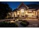 Elegant home entrance with a water fountain, stone accents, and manicured landscaping at 140 Lightship Dr, Mooresville, NC 28117
