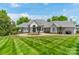 Beautiful front yard with circular driveway, lush lawn, and elegant landscaping at 140 Lightship Dr, Mooresville, NC 28117