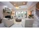 Inviting living room with fireplace, elegant seating, and views of the water at 140 Lightship Dr, Mooresville, NC 28117