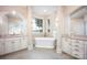 Luxurious main bathroom featuring a soaking tub, separate vanities, and natural light at 140 Lightship Dr, Mooresville, NC 28117
