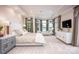 Serene main bedroom with tray ceilings, multiple windows with water views, and stylish furniture at 140 Lightship Dr, Mooresville, NC 28117