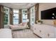 A luxurious main bedroom retreat showcasing water views, sitting area, and custom decor at 140 Lightship Dr, Mooresville, NC 28117