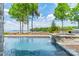 Inviting pool with a built-in spa, stone accents, and serene lake views, perfect for relaxation and outdoor entertainment at 140 Lightship Dr, Mooresville, NC 28117