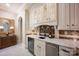 Stylish wet bar with custom cabinets, marble countertops, and a wine cooler at 140 Lightship Dr, Mooresville, NC 28117