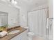 Bright bathroom featuring granite countertops, white cabinets, and a shower with white curtains at 140 Villa Lake Dr, Fort Mill, SC 29708
