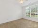 Bedroom with large window and neutral carpet, offers a bright and airy space at 140 Villa Lake Dr, Fort Mill, SC 29708