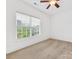 Sunlit bedroom with plush neutral carpet, white walls, and a large window at 140 Villa Lake Dr, Fort Mill, SC 29708