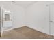 Empty carpeted room with an en suite bathroom, featuring white walls and doors at 140 Villa Lake Dr, Fort Mill, SC 29708