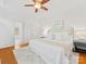 Bright bedroom with ceiling fan, hardwood floors, and ensuite bathroom provides a relaxing retreat at 140 Villa Lake Dr, Fort Mill, SC 29708