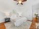 Bright bedroom with ceiling fan, hardwood floors, and ensuite bathroom provides a relaxing retreat at 140 Villa Lake Dr, Fort Mill, SC 29708