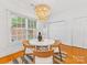 Bright dining area featuring modern lighting, a round table, and neutral décor with a view of the backyard at 140 Villa Lake Dr, Fort Mill, SC 29708