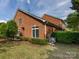 Brick home featuring a well-maintained lawn, trimmed bushes, and dual-pane windows at 140 Villa Lake Dr, Fort Mill, SC 29708