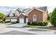 Charming brick home boasts a two-car garage and well-manicured landscaping, enhancing curb appeal at 140 Villa Lake Dr, Fort Mill, SC 29708