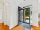 Bright, welcoming foyer with hardwood floors, a black door, and a view of the lush front yard at 140 Villa Lake Dr, Fort Mill, SC 29708