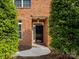 Inviting front entrance features a classic black door framed by lush greenery, enhancing curb appeal at 140 Villa Lake Dr, Fort Mill, SC 29708