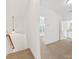 Bright hallway with neutral carpet, white walls, and natural light leading to other rooms at 140 Villa Lake Dr, Fort Mill, SC 29708