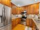This well-equipped kitchen features stainless steel appliances and wood cabinets, offering functionality and style at 140 Villa Lake Dr, Fort Mill, SC 29708