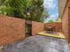 Secluded brick-walled patio with outdoor seating and a black iron gate at 140 Villa Lake Dr, Fort Mill, SC 29708
