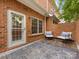 Private brick patio featuring outdoor seating, a white door, and bluestone pavers at 140 Villa Lake Dr, Fort Mill, SC 29708