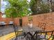 Cozy patio with brick walls, outdoor furniture, and lush greenery at 140 Villa Lake Dr, Fort Mill, SC 29708