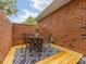 Private brick patio with outdoor dining set on wood platform with patterned rug at 140 Villa Lake Dr, Fort Mill, SC 29708