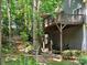 View of the multi-tiered deck and stone staircase leading to a lush backyard at 16134 Tinura Ct # 134, Tega Cay, SC 29708