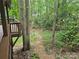 Backyard stone path leading to pergola from deck with mature trees at 16134 Tinura Ct # 134, Tega Cay, SC 29708