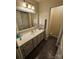 Cozy bathroom with a white sink, tile flooring, and a large mirror at 16134 Tinura Ct # 134, Tega Cay, SC 29708