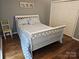 This is a quaint bedroom with wood flooring and a closet for storage at 16134 Tinura Ct # 134, Tega Cay, SC 29708