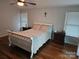 Well-lit bedroom with hardwood floors, two windows, and a ceiling fan at 16134 Tinura Ct # 134, Tega Cay, SC 29708