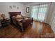 This is a lovely bedroom with hardwood flooring and a large window for natural lighting at 16134 Tinura Ct # 134, Tega Cay, SC 29708