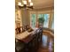 Dining room with view of landscaped yard through bay window; hardwood floor and decorative chandelier at 16134 Tinura Ct # 134, Tega Cay, SC 29708
