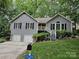 Inviting home with a two-car garage, landscaped yard, and charming front porch stairs at 16134 Tinura Ct # 134, Tega Cay, SC 29708