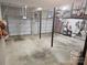 A spacious two-car garage equipped with shelving, tools, and ample storage space at 16134 Tinura Ct # 134, Tega Cay, SC 29708