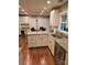 A spacious kitchen featuring an island, white cabinetry, and stainless steel appliances at 16134 Tinura Ct # 134, Tega Cay, SC 29708